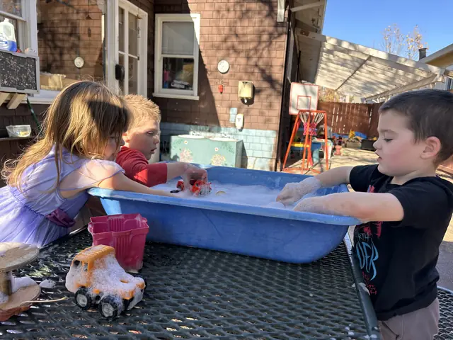 Children playing at an outdoor water tray