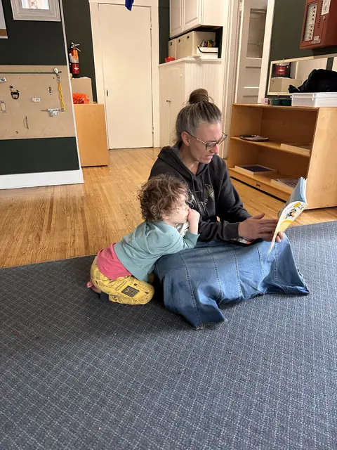 A teacher reading one to one with a child
