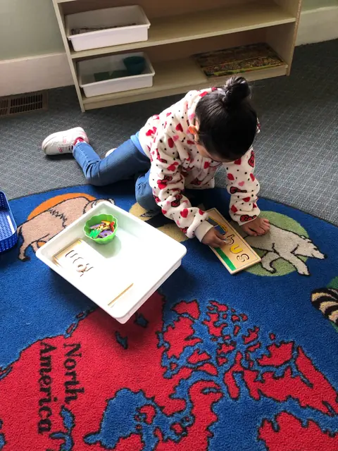 A child building words with letter tiles